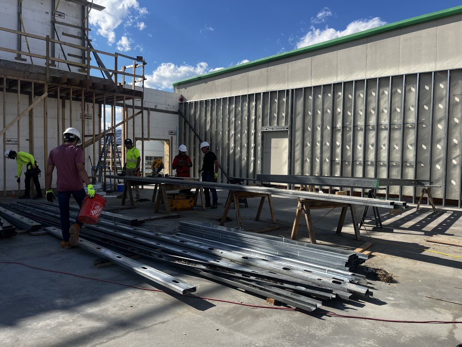 Crew staging and erecting structural steel framing on a commercial site
