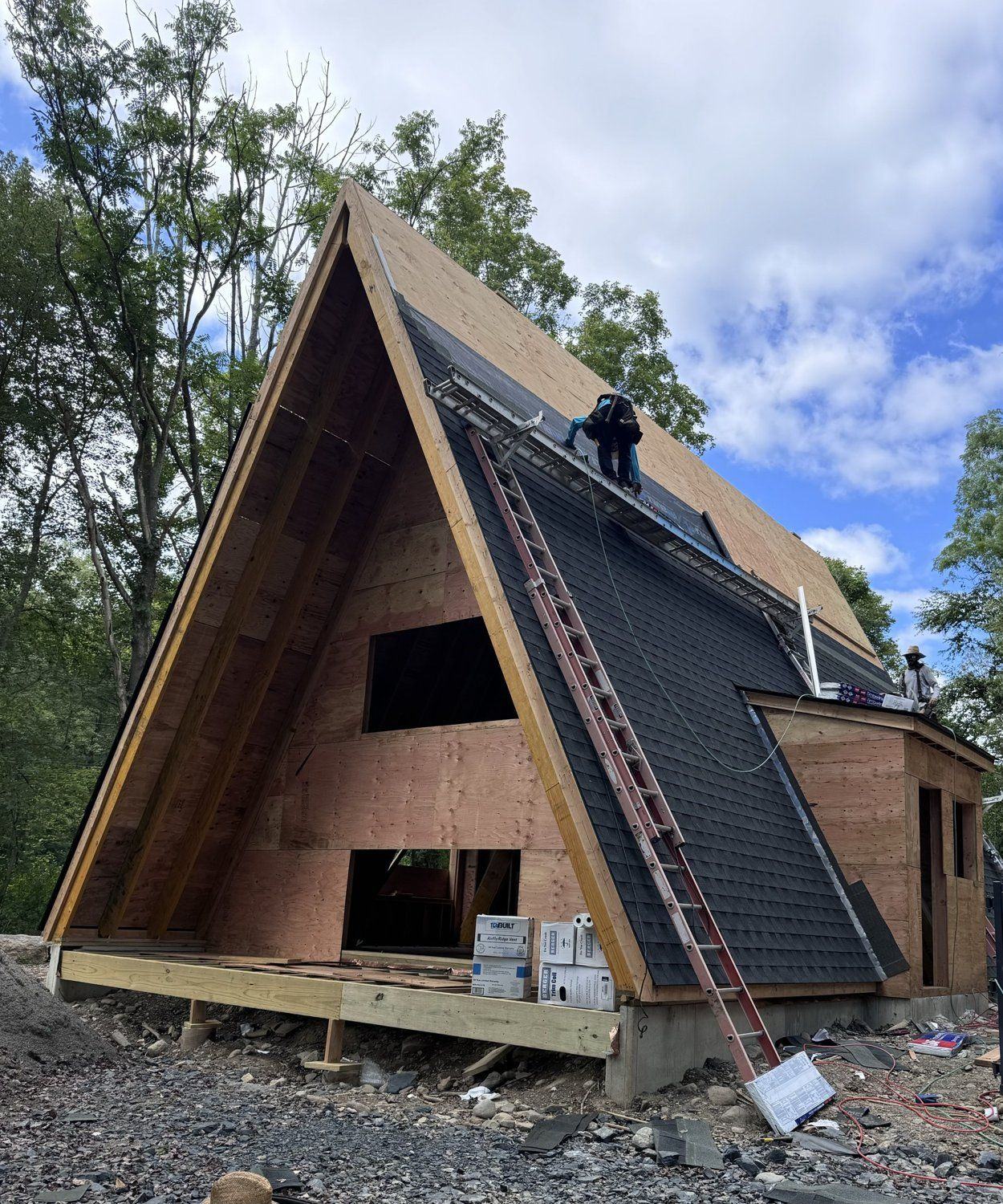 A-frame home under construction — roof and exterior in progress